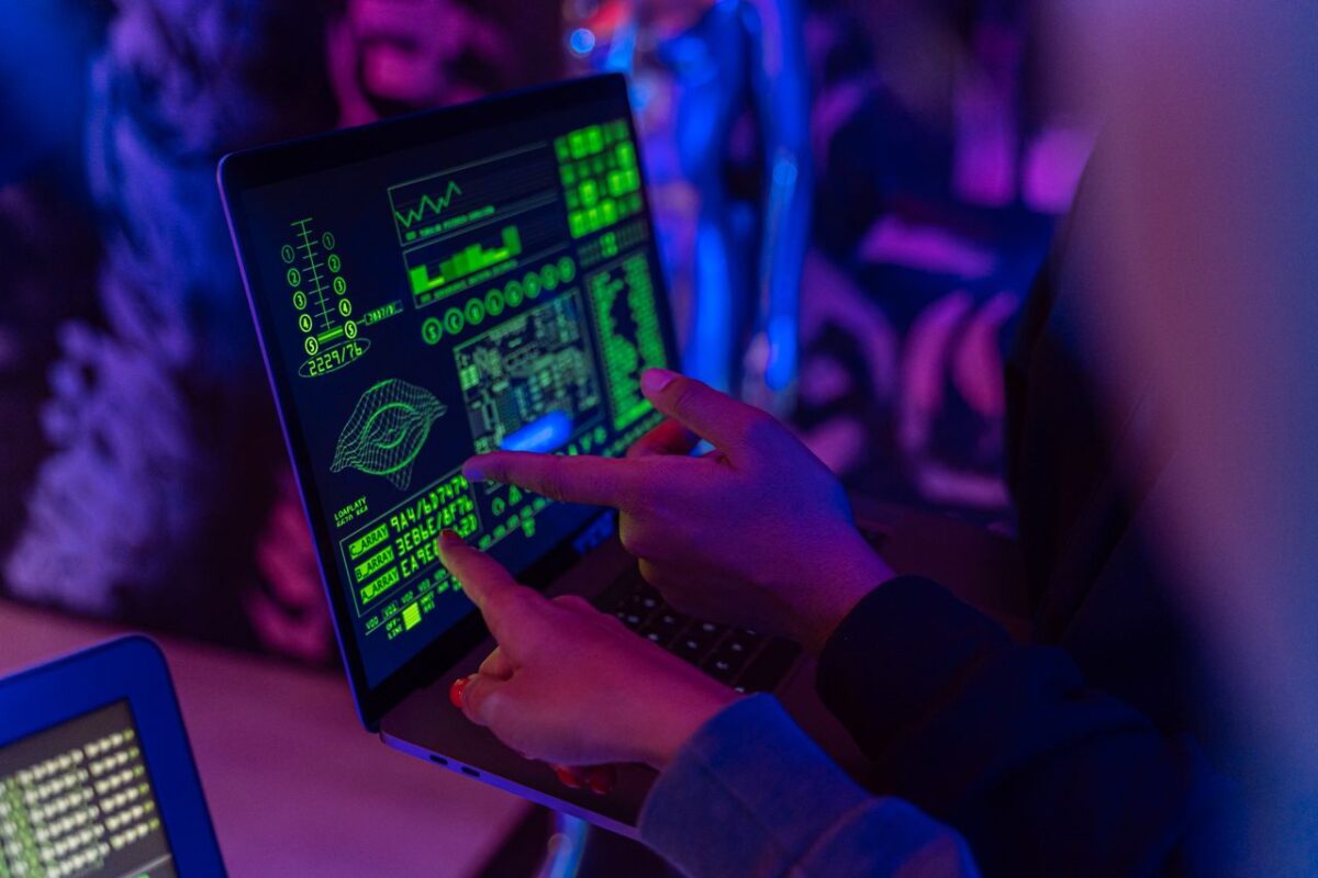 Respublicanova A person analyzing cybersecurity data on a laptop in a dimly lit room.